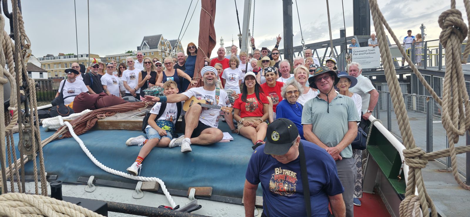 A large group of people gathered together for a community music day aboard the Will, a Thames sailing barge at Gravesend