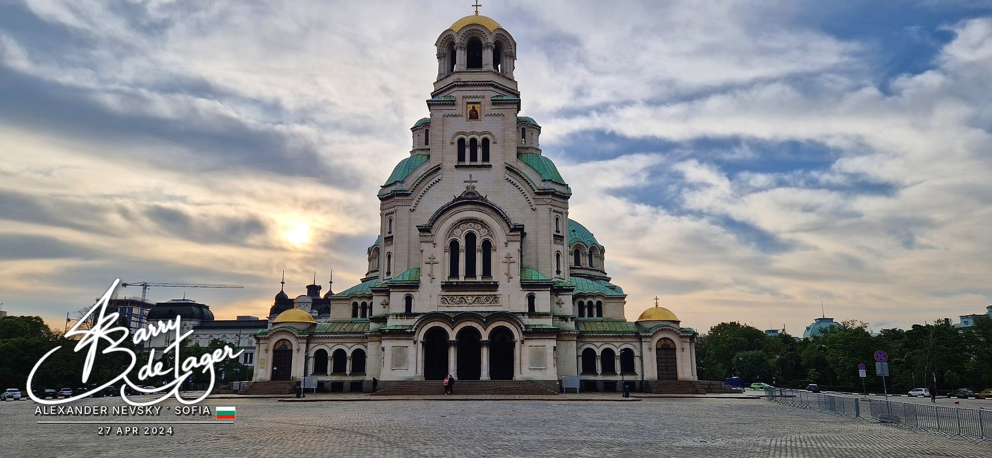 Alexander Nevsky Cathedral with its green and gold domes under a dramatic evening sky in Sofia