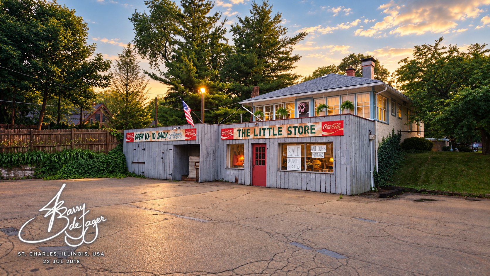The Little Store, a weathered clapboard shop with Coca-Cola signs and an American flag, at sunset in St Charles